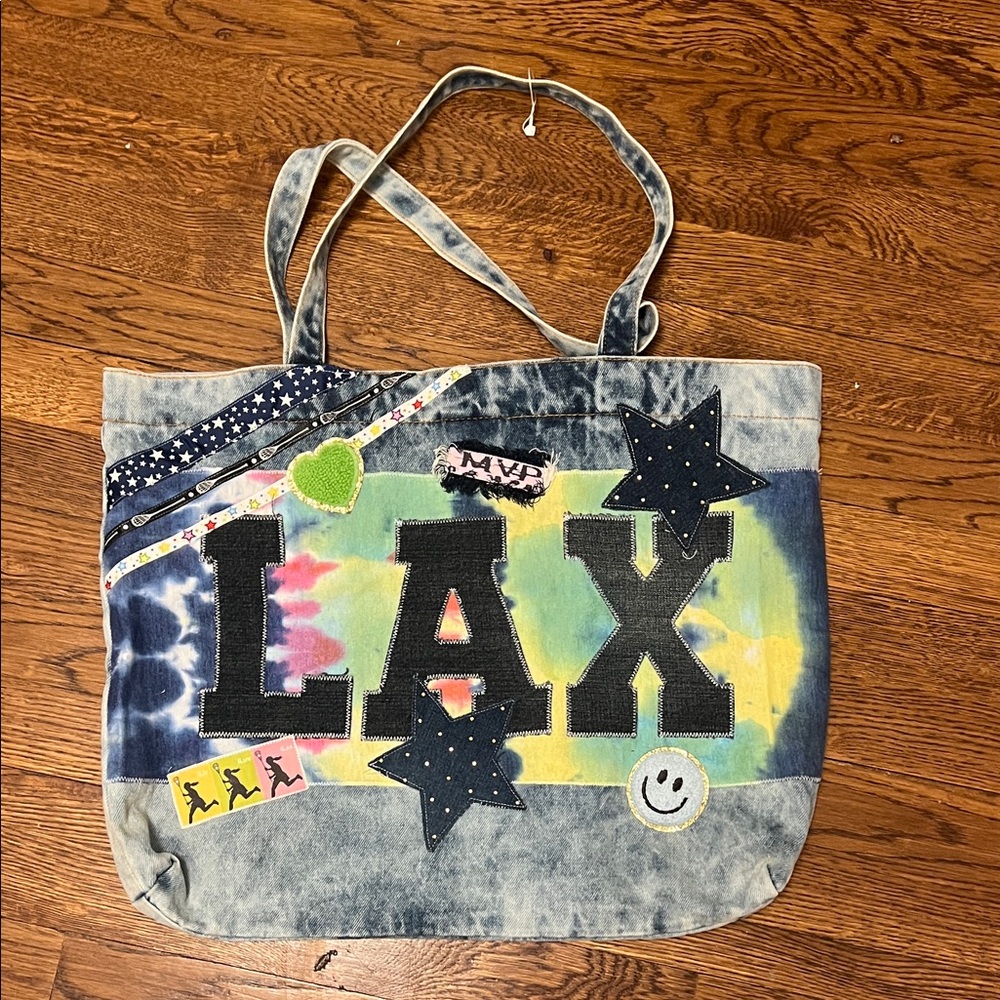 Stylish new boutique lax denim bag with snap closure.